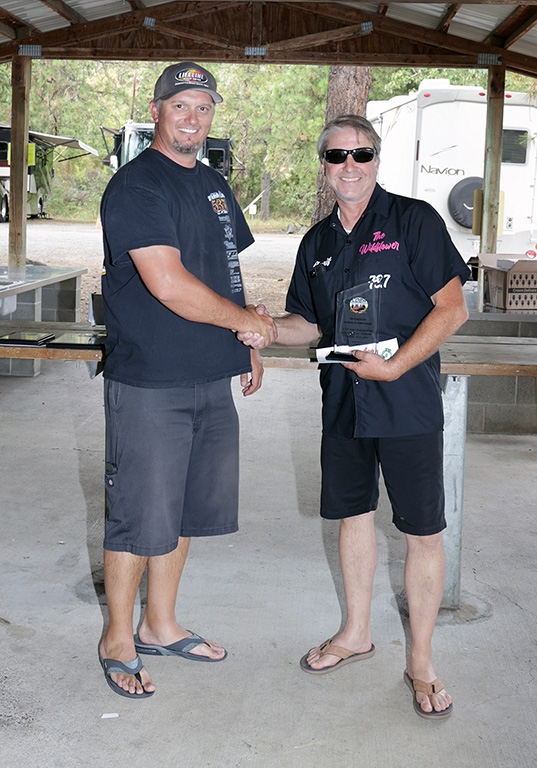 Dennis Flint collecting his Stock Eliminator runner up trophy. He's been enjoying some busy race days this season.